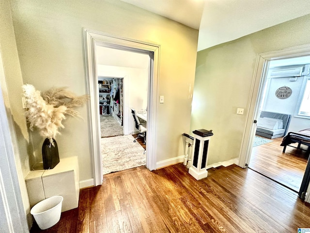 corridor with dark wood finished floors and baseboards