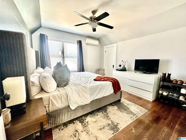 bedroom with an AC wall unit, wood finished floors, a ceiling fan, and vaulted ceiling