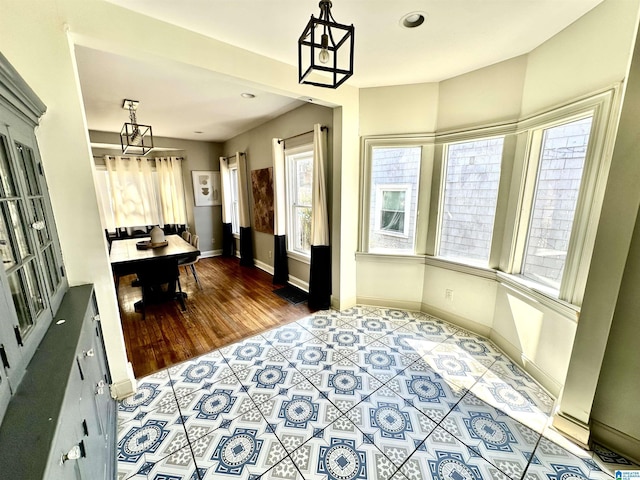 dining room with a notable chandelier, recessed lighting, and baseboards