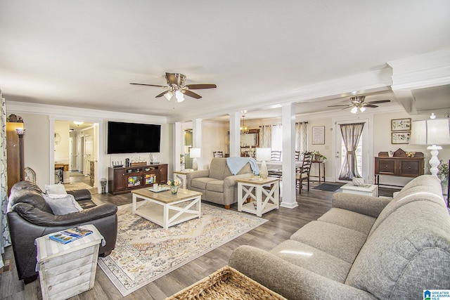 living area with crown molding, dark wood-style floors, ornate columns, and ceiling fan