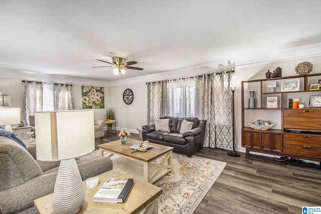 living room featuring dark wood-style floors, baseboards, ornamental molding, and a ceiling fan