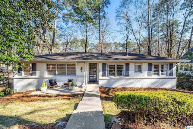 ranch-style house with brick siding and stucco siding