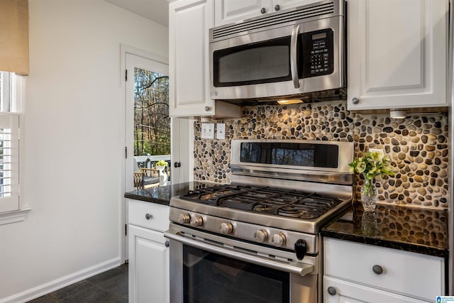 kitchen featuring white cabinetry, a wealth of natural light, tasteful backsplash, and appliances with stainless steel finishes