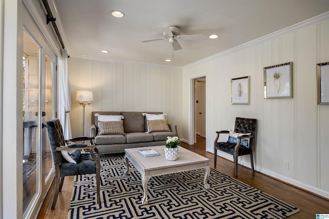 living area with dark wood finished floors, recessed lighting, crown molding, and a ceiling fan