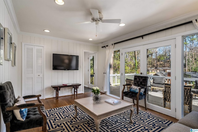 living area featuring plenty of natural light, recessed lighting, crown molding, and wood finished floors