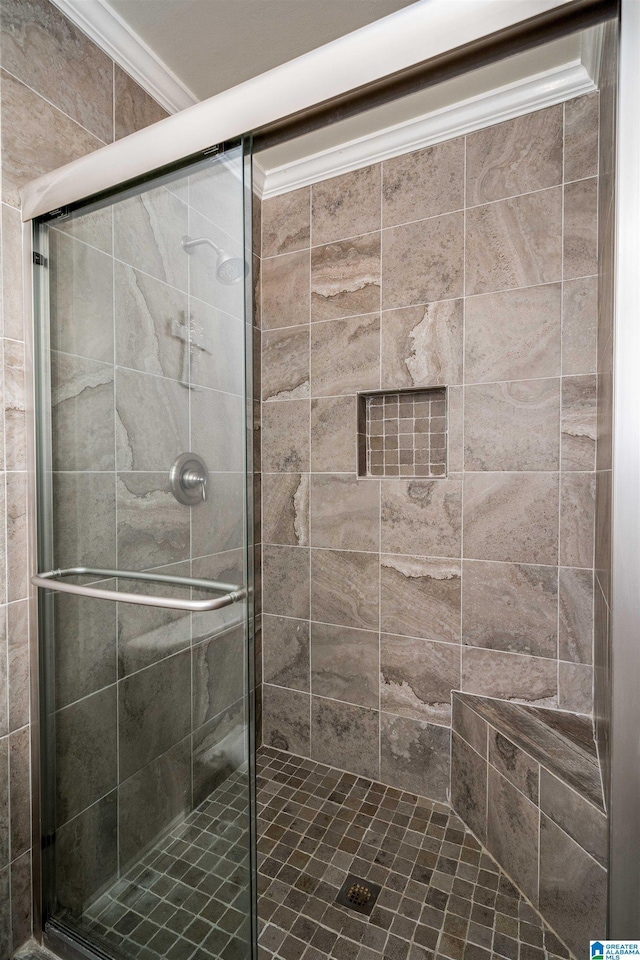 full bath with a stall shower and ornamental molding