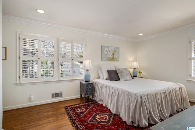 bedroom featuring visible vents, ornamental molding, wood finished floors, recessed lighting, and baseboards