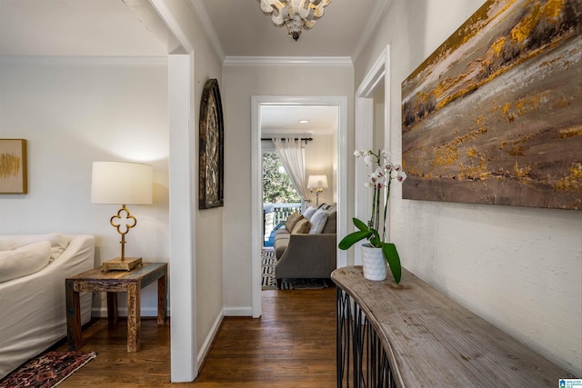 hallway with wood finished floors, baseboards, and ornamental molding