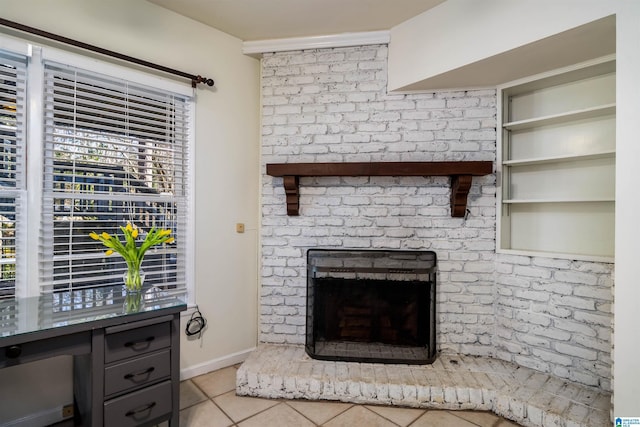 tiled living room with a brick fireplace and baseboards