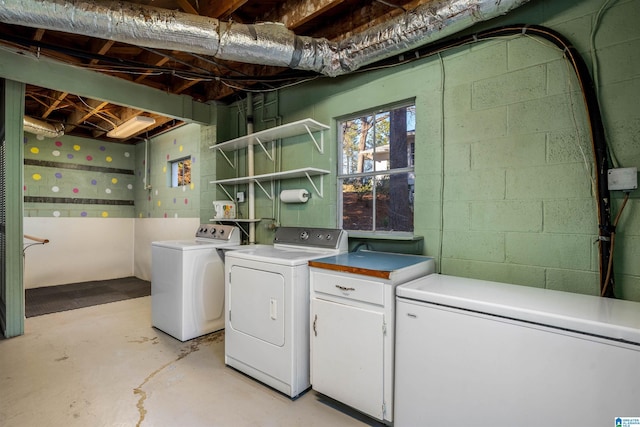 washroom featuring laundry area and washing machine and clothes dryer