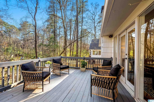 wooden deck with an outdoor living space