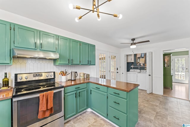 kitchen featuring a peninsula, stainless steel electric range, under cabinet range hood, washing machine and dryer, and tasteful backsplash