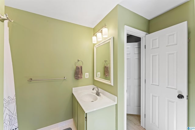 bathroom with baseboards and vanity