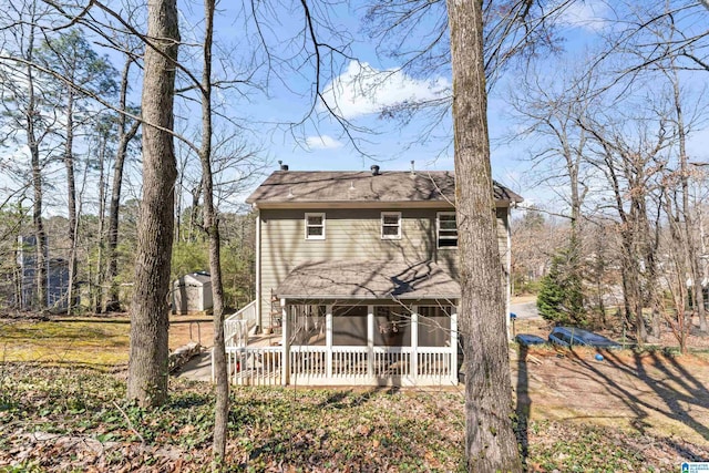 rear view of property featuring a sunroom