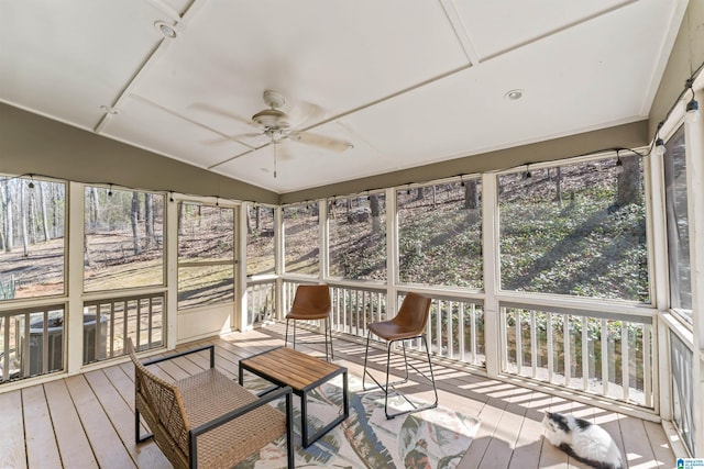 sunroom featuring ceiling fan