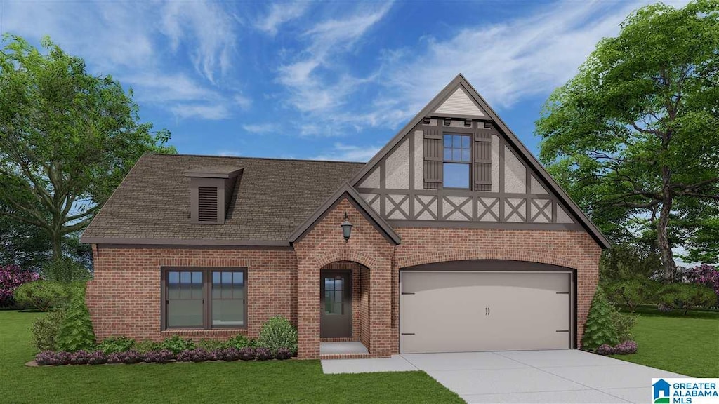 tudor home with a front yard, driveway, a shingled roof, a garage, and brick siding