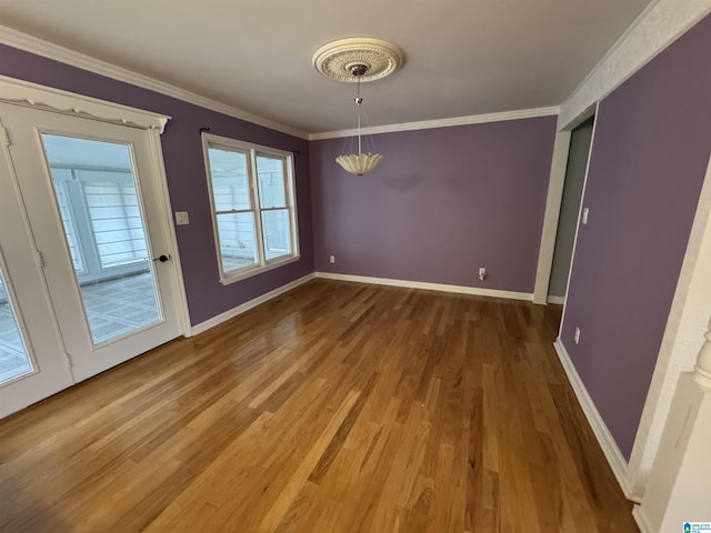 unfurnished dining area with wood finished floors, baseboards, and ornamental molding