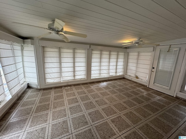 unfurnished sunroom with a ceiling fan