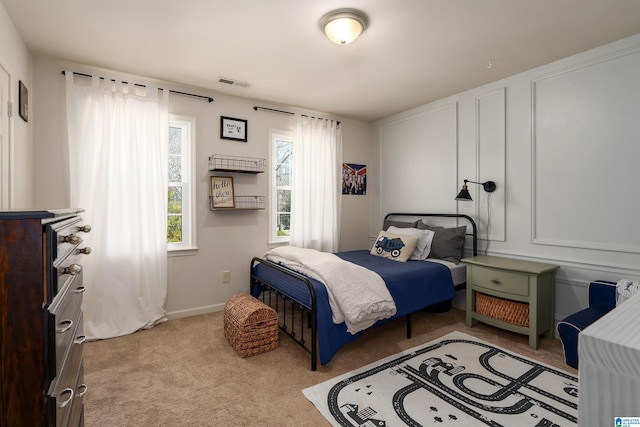 carpeted bedroom featuring baseboards and visible vents