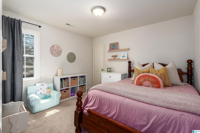 bedroom with visible vents and carpet floors