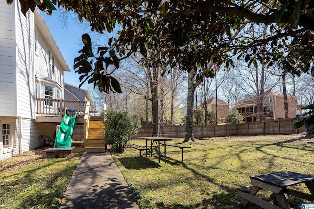 view of yard with stairs, fence, and a wooden deck