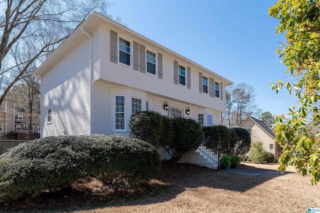 view of side of home featuring brick siding