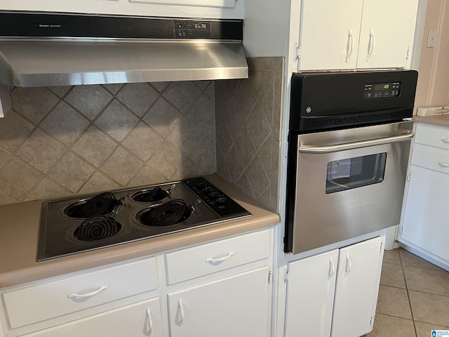 kitchen with range hood, white cabinets, backsplash, and appliances with stainless steel finishes