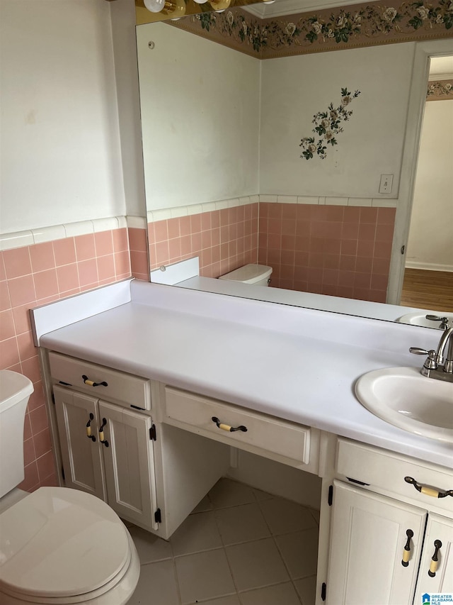 bathroom featuring vanity, tile walls, toilet, and tile patterned flooring