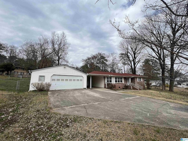 ranch-style home with concrete driveway, a garage, and fence