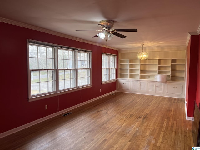 interior space with visible vents, wood finished floors, and crown molding