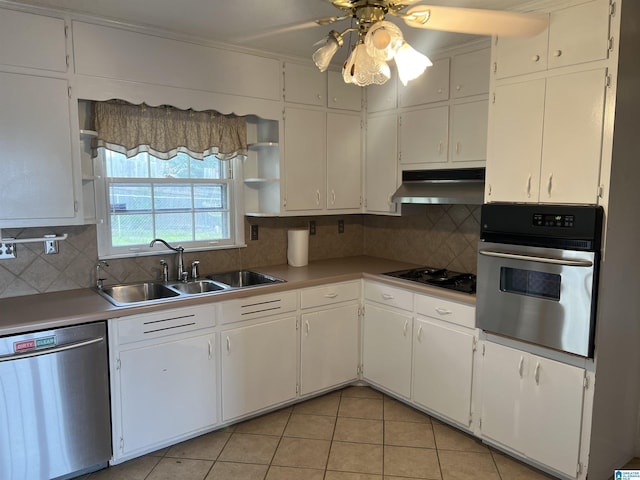 kitchen with a sink, under cabinet range hood, decorative backsplash, appliances with stainless steel finishes, and open shelves