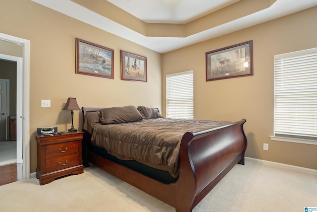 bedroom with baseboards and carpet