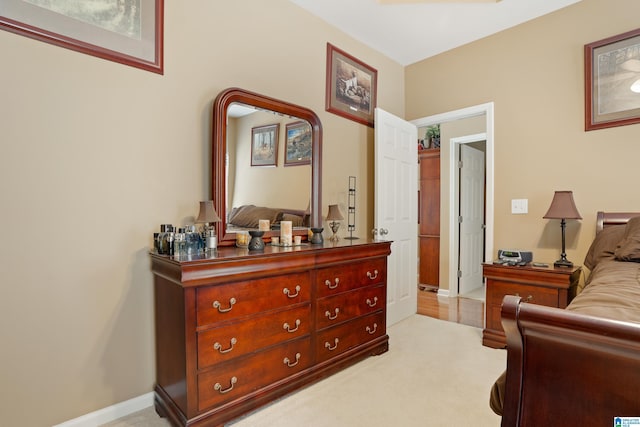 bedroom featuring light colored carpet and baseboards