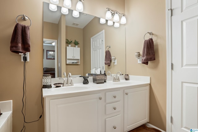 ensuite bathroom featuring double vanity, visible vents, ensuite bath, and a sink