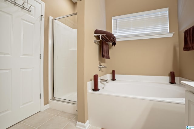 full bathroom featuring tile patterned floors, a bath, and a shower stall