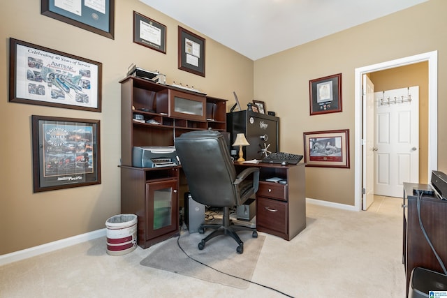 home office with baseboards and light colored carpet