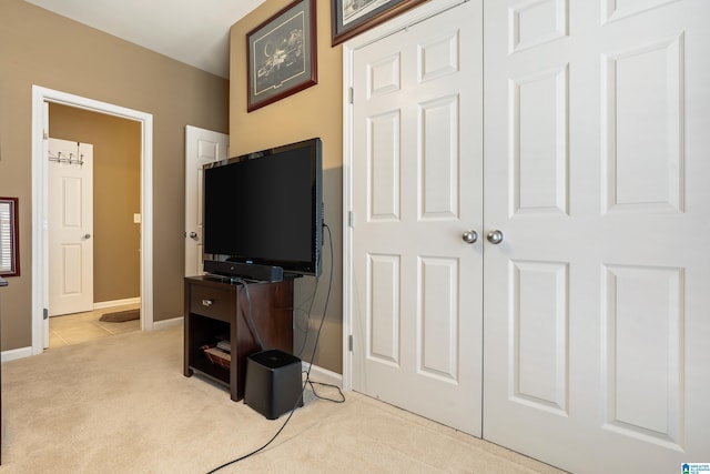 living room featuring light colored carpet and baseboards