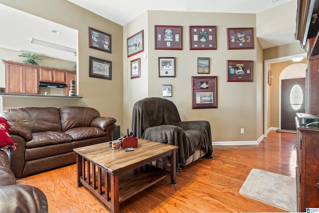 living area featuring light wood-style flooring and baseboards