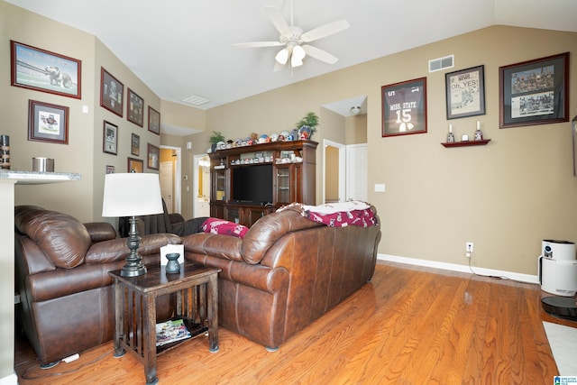 living room with light wood finished floors, visible vents, baseboards, and vaulted ceiling