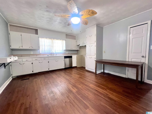 kitchen with dishwasher, light countertops, baseboards, and dark wood-type flooring