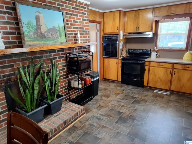 kitchen with visible vents, black appliances, light countertops, under cabinet range hood, and stone finish flooring