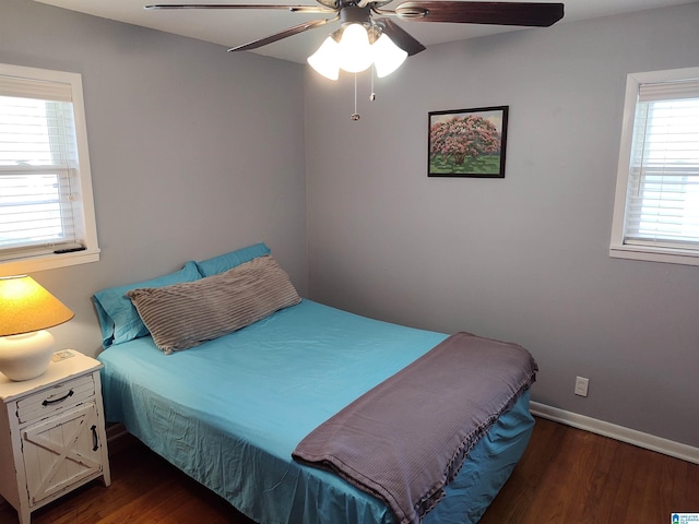 bedroom featuring baseboards, wood finished floors, and a ceiling fan