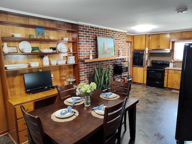 dining space with ornamental molding and stone finish floor