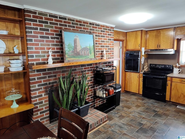 kitchen with black appliances, under cabinet range hood, stone finish flooring, brown cabinets, and a large fireplace