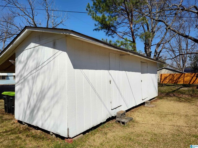 view of outbuilding with an outbuilding and fence