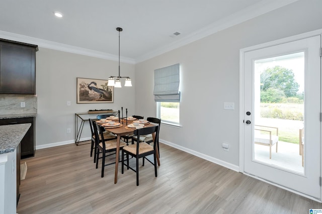 dining room with light wood finished floors, recessed lighting, baseboards, and ornamental molding