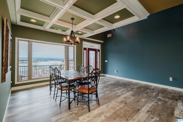 dining room with a chandelier, coffered ceiling, baseboards, and wood finished floors