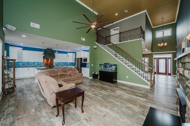 living area featuring stairway, wood finished floors, baseboards, and a wealth of natural light