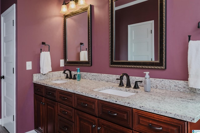 full bathroom featuring a sink and double vanity