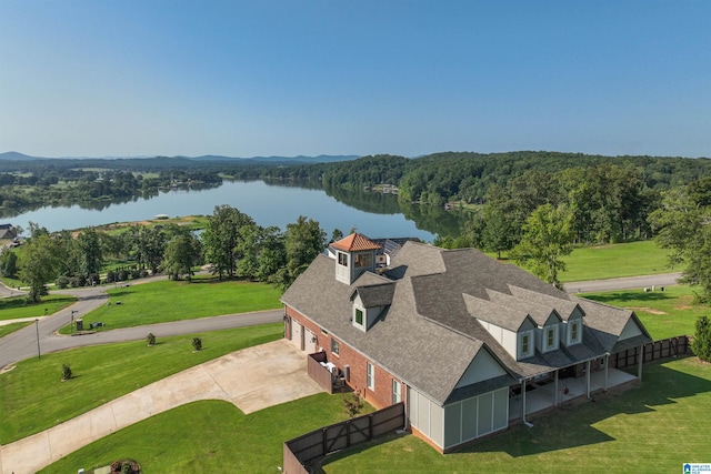 bird's eye view featuring a wooded view and a water view